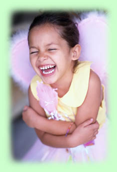 Little girl dress-up laughing with wings
