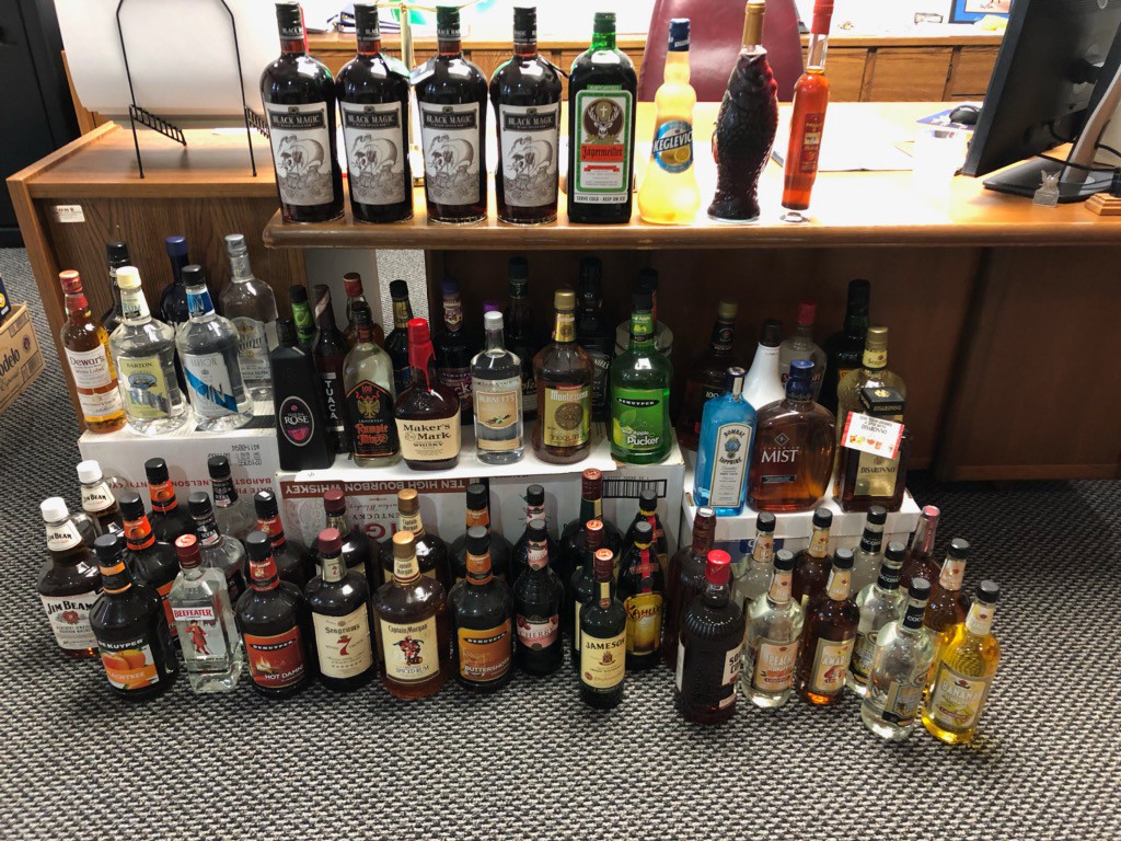liquor bottles in front of a desk