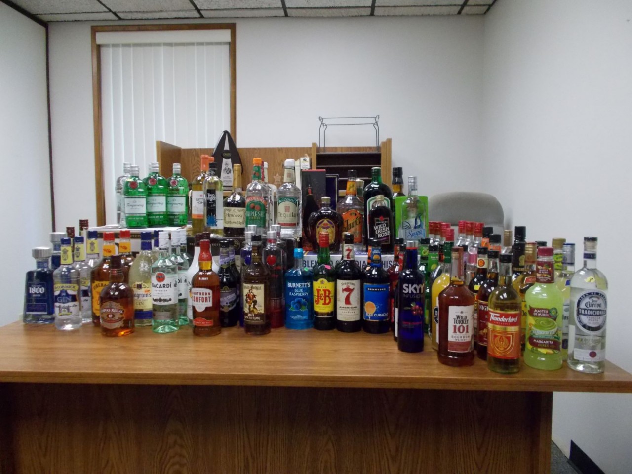 lots of liquor bottles on top of a table