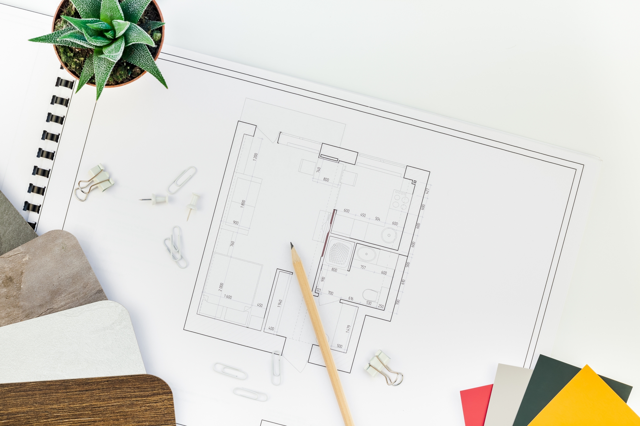 Architecture - Interior designer table workplace with house plan Architecture - Interior designer table workplace with house plan - creative flat lay overhead top view blueprints architectural flat project plan and office supplies on decorator white table workspace with swatches tools and equipment background copy space concept