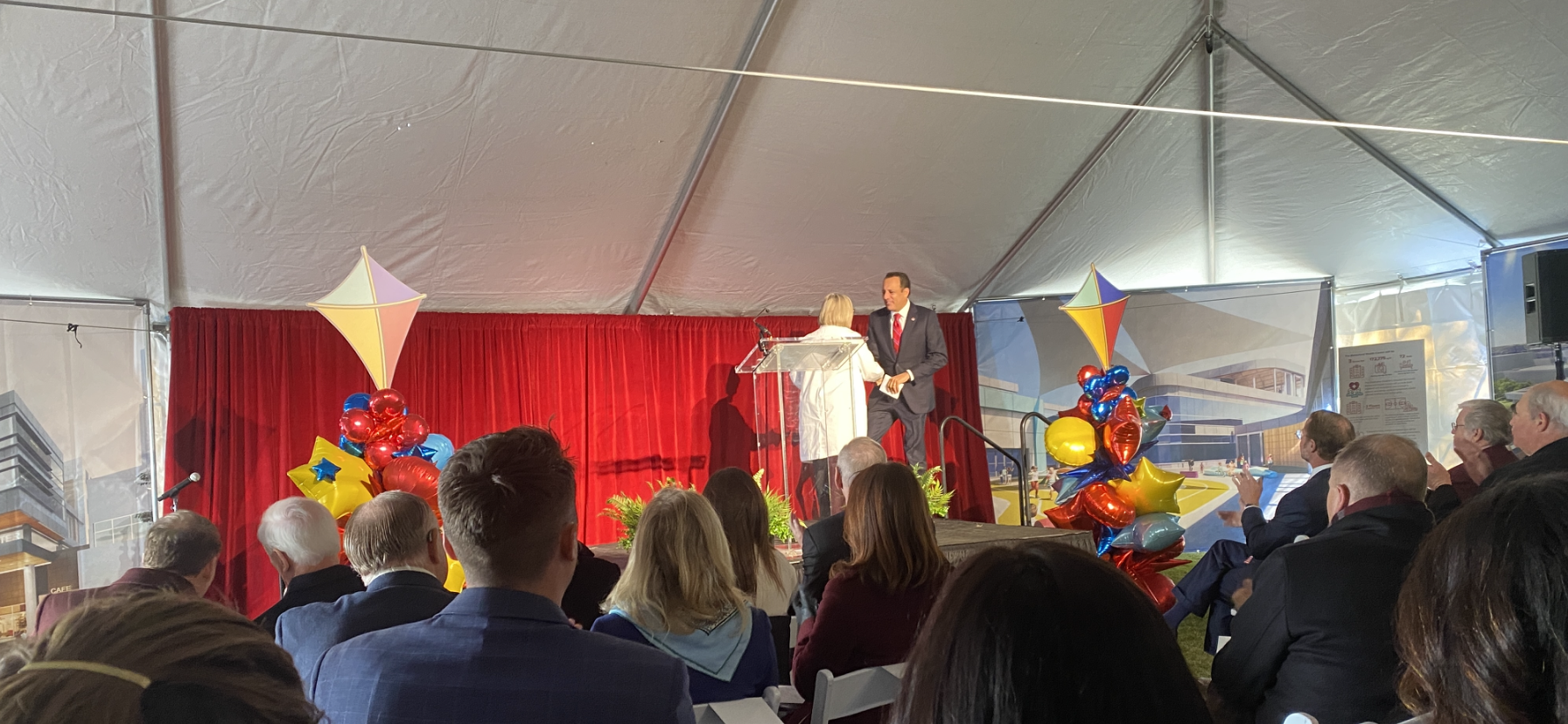 Dr. Joseph Harroz Jr., president of OU, shakes hands with Dr. Robyn Cowperthwaite, child and adolescent psychiatrist, as he approches the podium to speak at the children's behavioral health center groundbreaking ceremony.