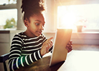 success-at-home-image Young girl using an iPad at home