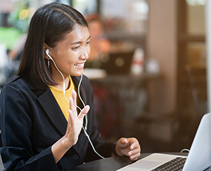 informationalinterview04 close up asian woman use earphone connect to laptop and talking greeting by video conference with friends or family at outdoor coffee restaurant in relax time , lifestyle people concept