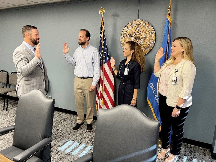 Oklahoma CareerTech State Director Brent Haken, left, swears in board members, from left, Rob Seeman, Suzanne Reynolds and Kendra Wesson.