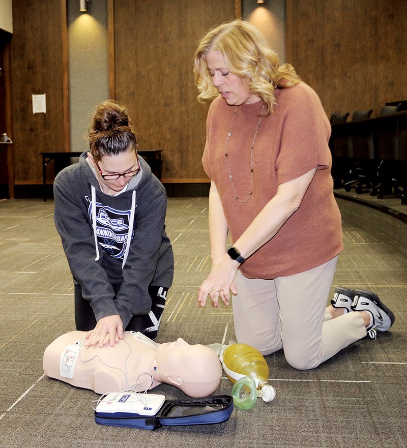 Program instructor Melissa Powell, right, and Kimberly Guitard of Ringwood, a student in the hybrid CNA program at NWTC, participate in CPR certification, one of the requirements needed to become a licensed CNA.