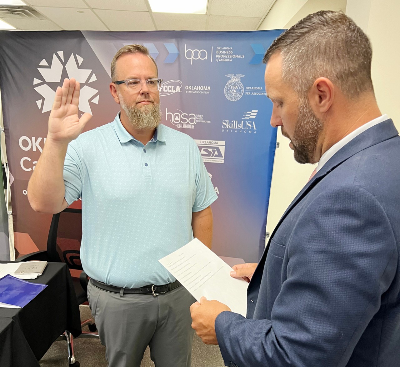 Oklahoma CareerTech State Director Brent Haken, right, swears in new Oklahoma Board of Career and Technology Education member Zach Archer at the July 18, 2024, board meeting.