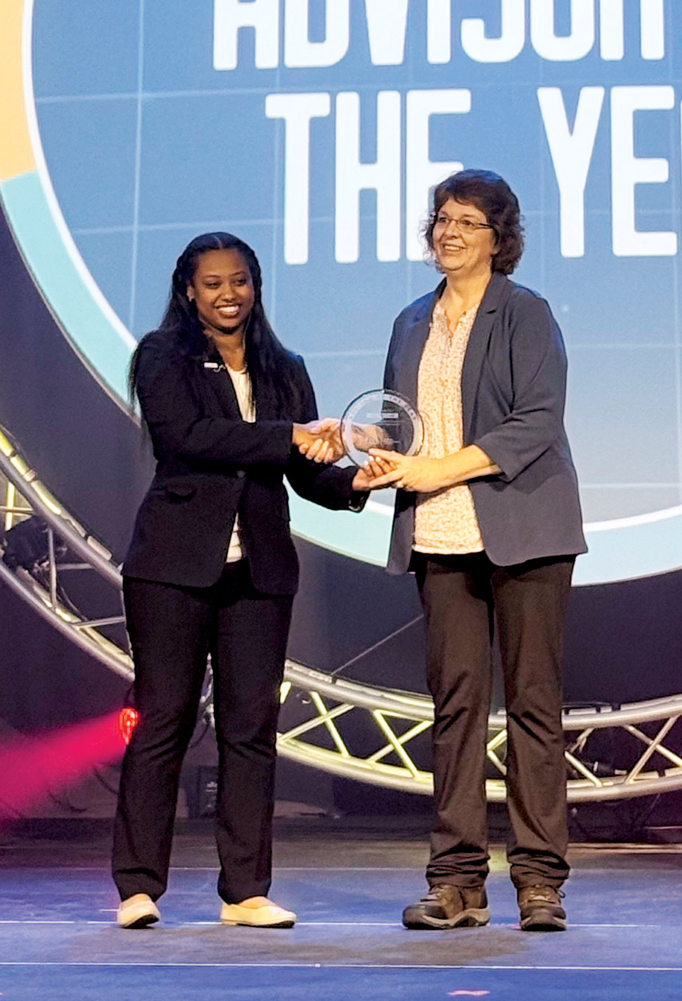 Amy McClure, right, Northwest Technology Center - Fairview, receives the Advisor of the Year award at the Business Professionals of America 2025 National Leadership Conference.