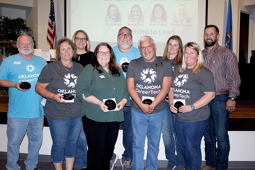 The Teaching to Lead Instructional Coaching Team received the Team Award. Pictured are, from left, Brian Campbell, Karen Talbott, Cara Pattison, Nancy Rodriguez (accepting for the late Tessa Lazor), Mitchell Thomas, Stephen Aragon, Renee Reed and Virginia Oden. With them is State Director Brent Haken, right.