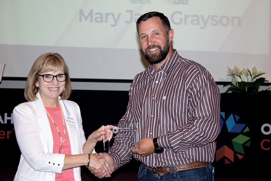 Mary Jane Grayson, left, received the Leadership in Achieving Excellence Award. With her is State Director Brent Haken.