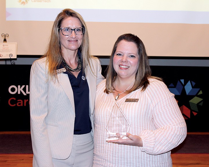 Kerri Watkins, information management manager, right, received the Leadership in Achieving Excellence Pinnacle Award. With her is State Director Marcie Mack.