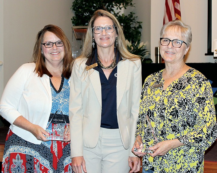 Recipients of the Excellence in Customer Service PInnacle Awards were Melissa Sturgeon, human resources manager, left, and Connie Lewis, communications and marketing administrative assistant, right. With them is State Director Marcie Mack.