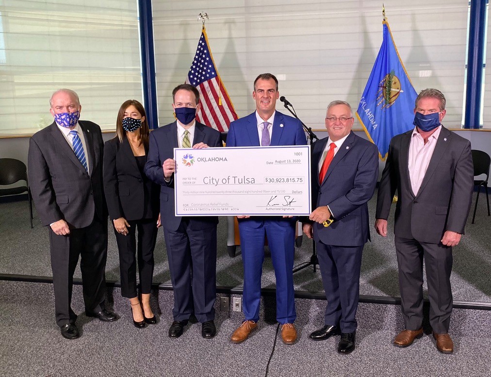 Governor Stitt at City of Tulsa press conference displaying ceremonial check