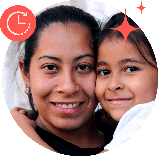 Young Hispanic mother holding her daughter. Both are smiling.