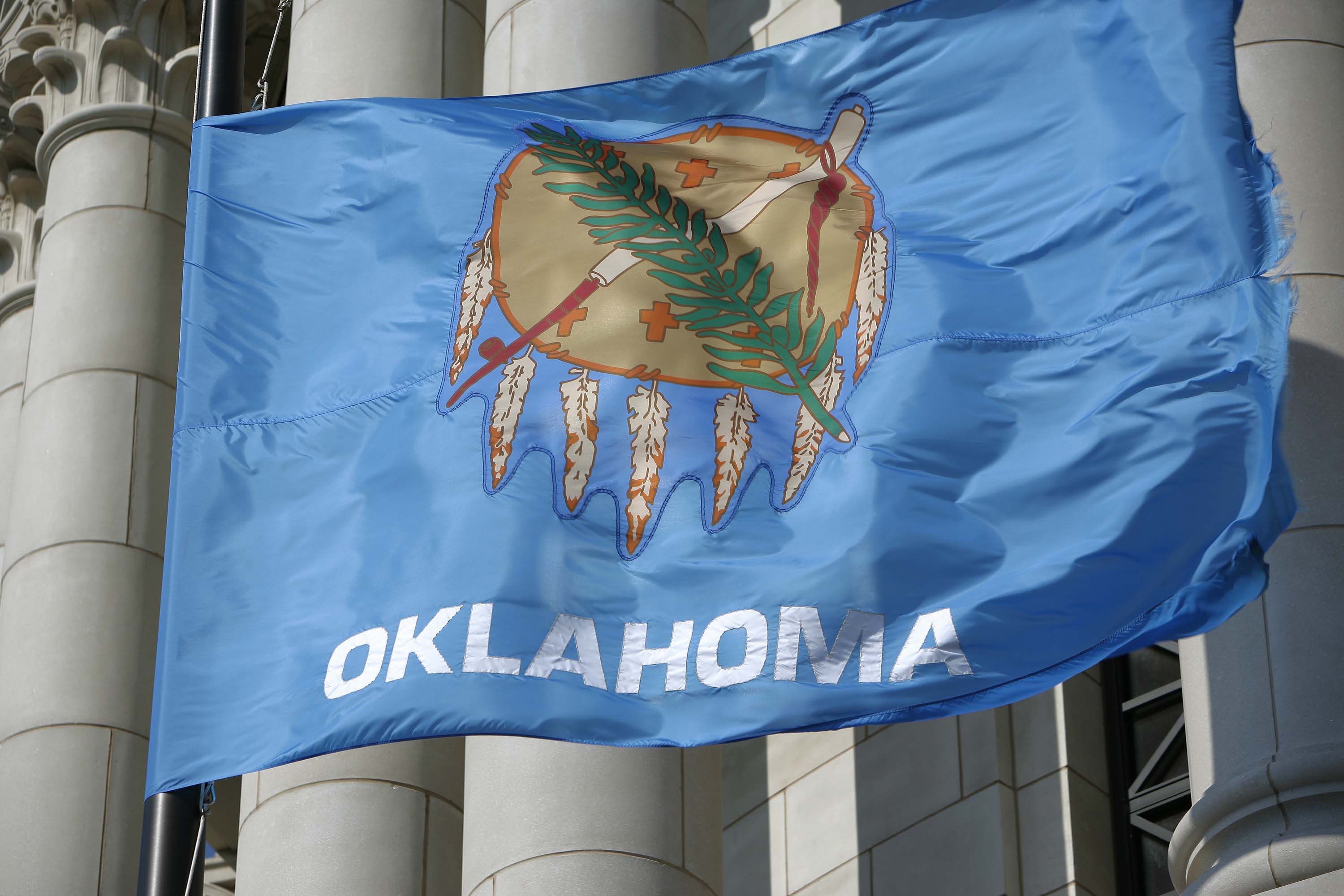 oklahoma flag flying in front of state capitol