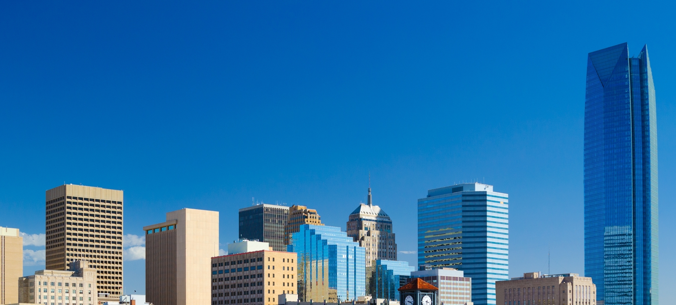 Oklahoma downtown skyline with a deep blue sky, featuring the new Devon Energy Center building.