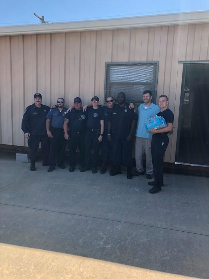 Group of Mabel Bassett Correctional Center staff delivering water to area fire department.