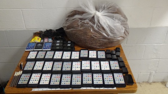 The contraband drop contianed 39 cellphones and nearly 10 pounds of tobacco.