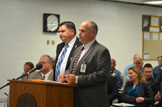 Oklahoma DOC Region II Director David Parker (right) introduces Mike Bolt to corrections board members as the agency's new warden of the John Lilley Correctional Center in Boley.