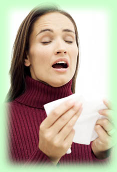 Woman about to sneeze into a tissue