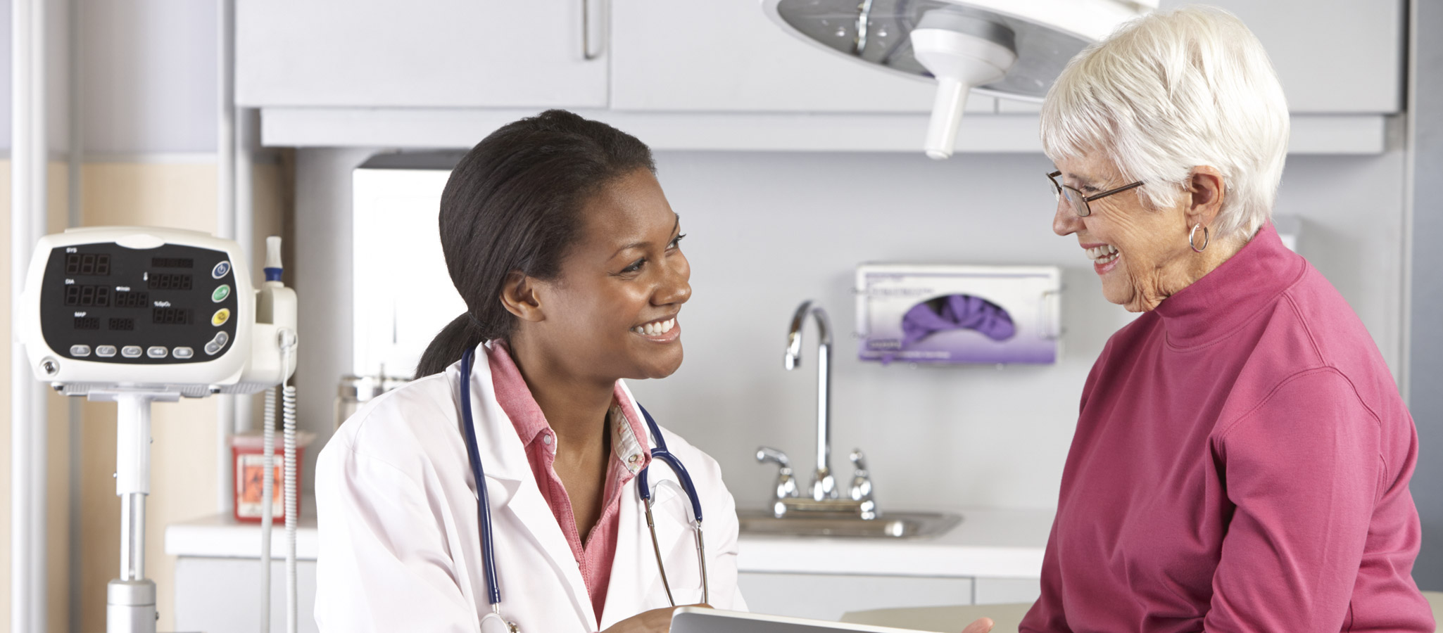Doctor-Discussing-Records-With-Senior-Female-Patient