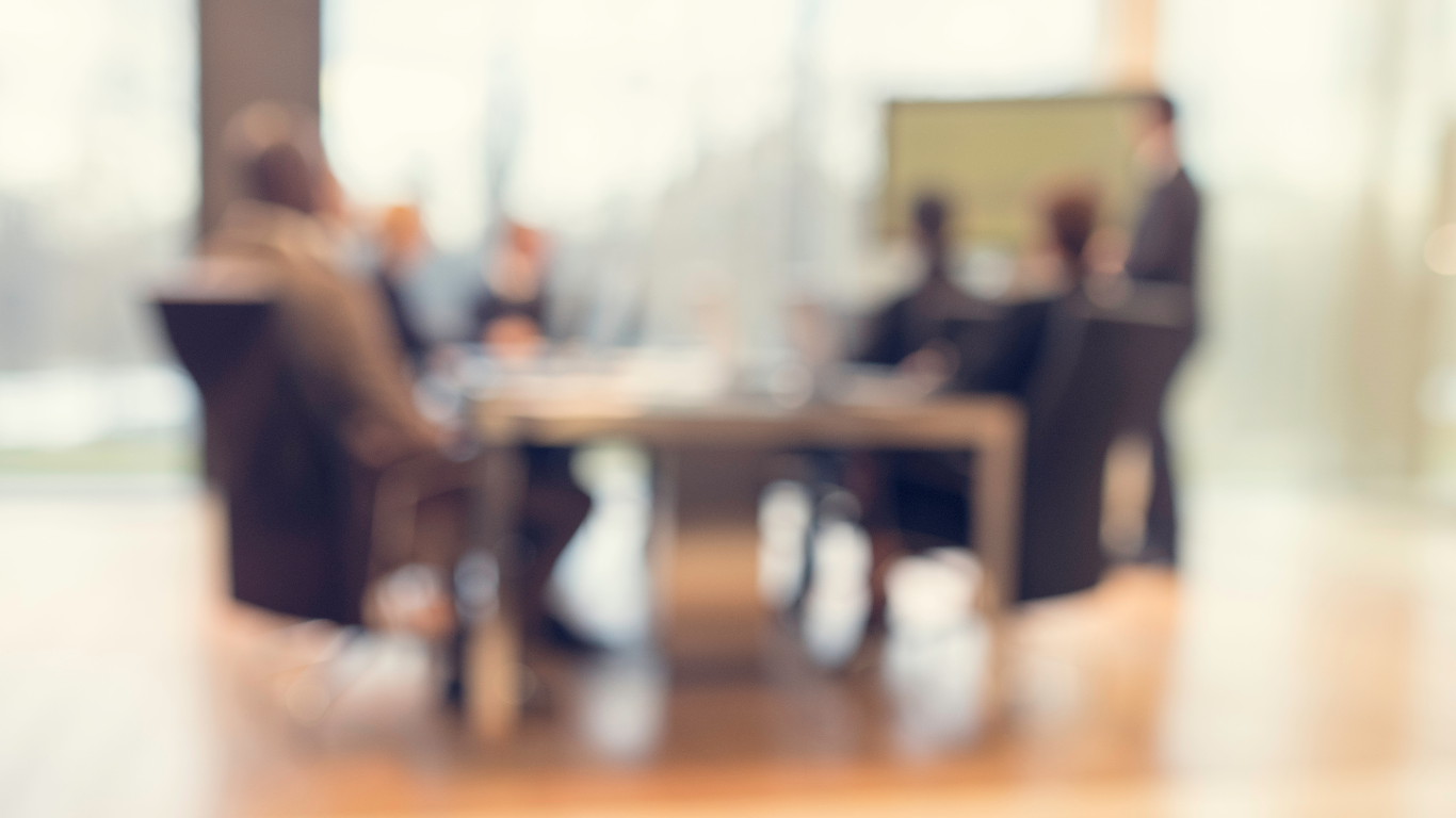 Blurred people in a business meeting sitting in a room
