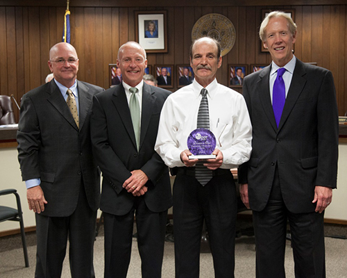 The Progressive Excellence Award, which is presented to the Oklahoma Department of Transportation field division which  has most improved its safety rating during the past year, was awarded to ODOT Division One, headquartered in Muskogee, at the April 6 Transportation Commission meeting. The division improved its safety performance 91 percent from last year. Pictured left to right are Oklahoma Transportation Commission Chairman David Burrage, Transportation Commission Division One member John Fidler, Saliba and ODOT Executive Director Mike Patterson. 