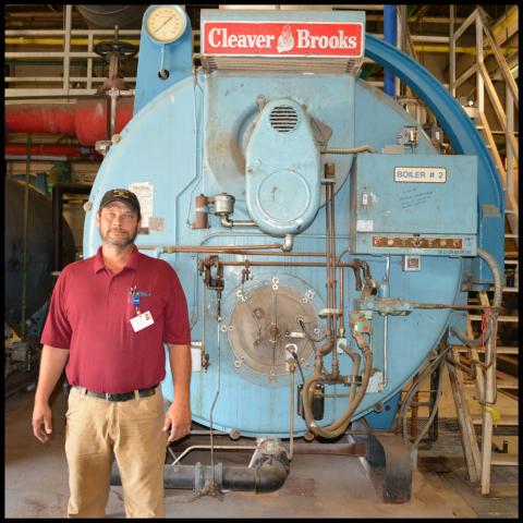 Pippins stands in front of a chiller that is more than 12 feet tall and 8 wide.