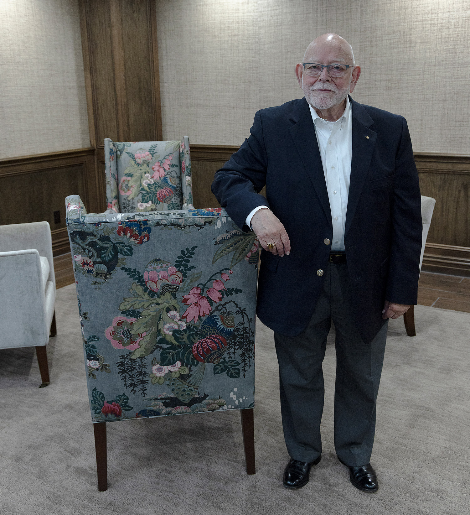 Larry Duffy smiling while standing next to a chair