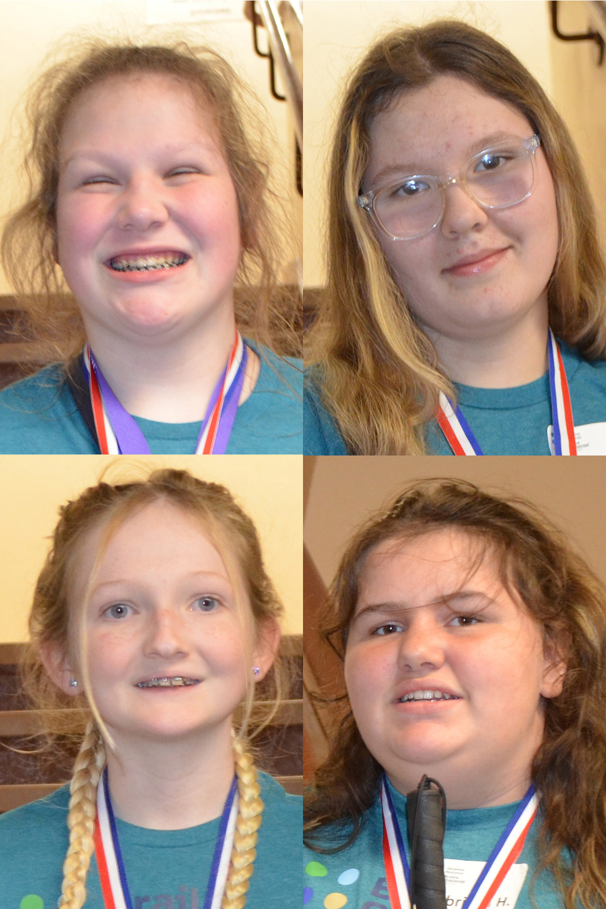 4 smiling young women with ribbons around their necks