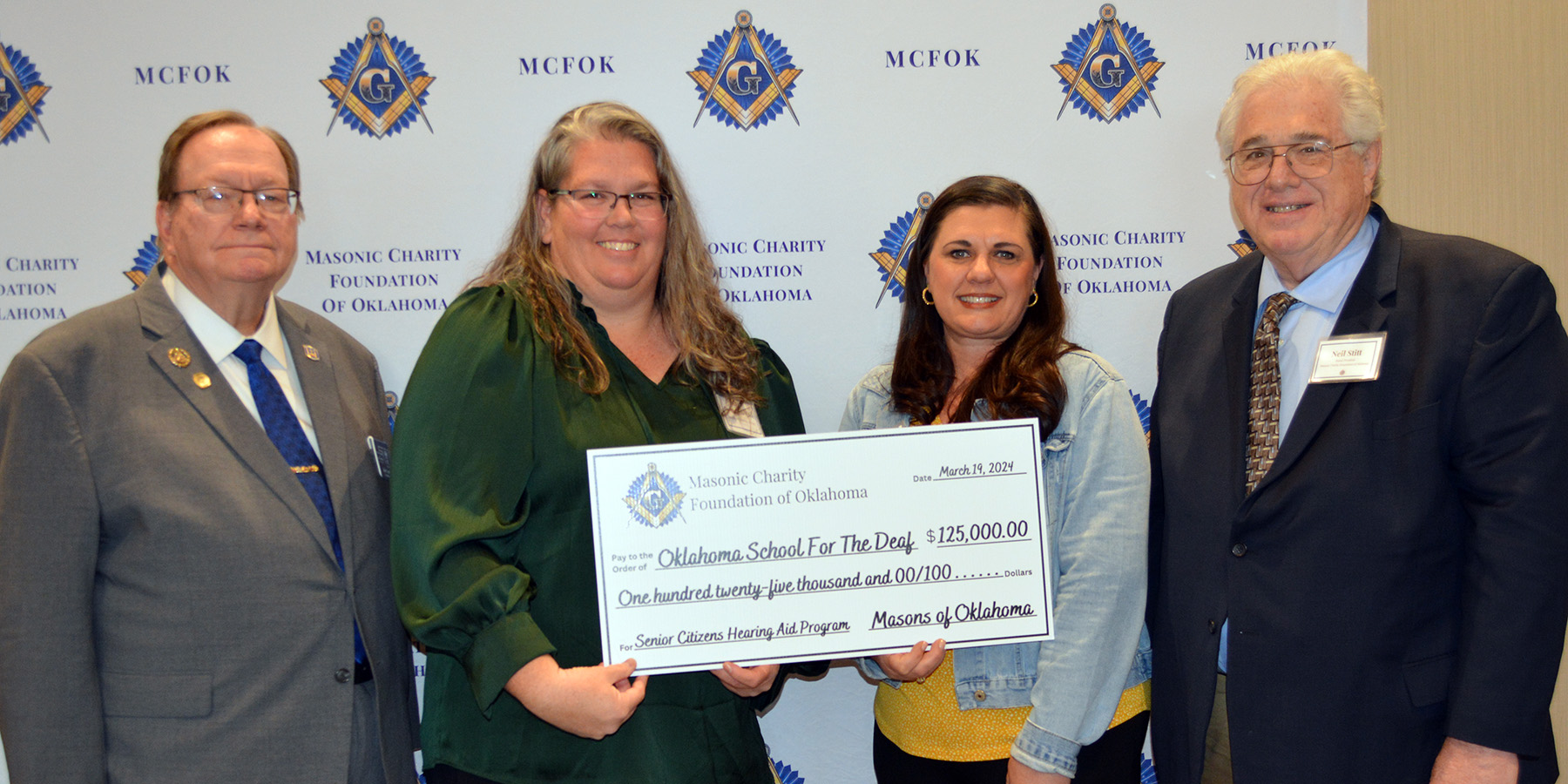 4 people hold a $125,000 check from Masonic Charity Foundation of OK