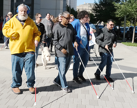 Group of people walking with canes.