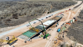 Flyover shot of concrete being poured on SH-94 bridge near Guymon, Okla.