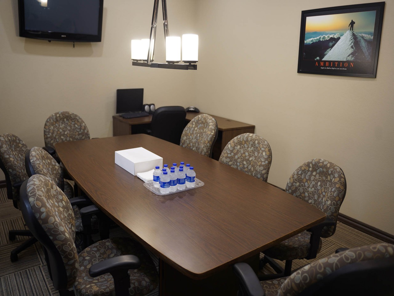 Conference or training room with available TV and tables/chairs.      