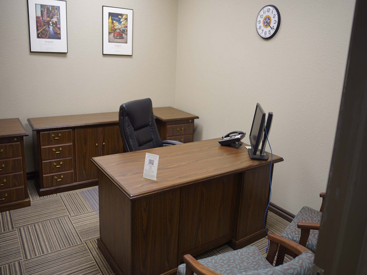 Interview Room with desk, cabinets, computer and phone.