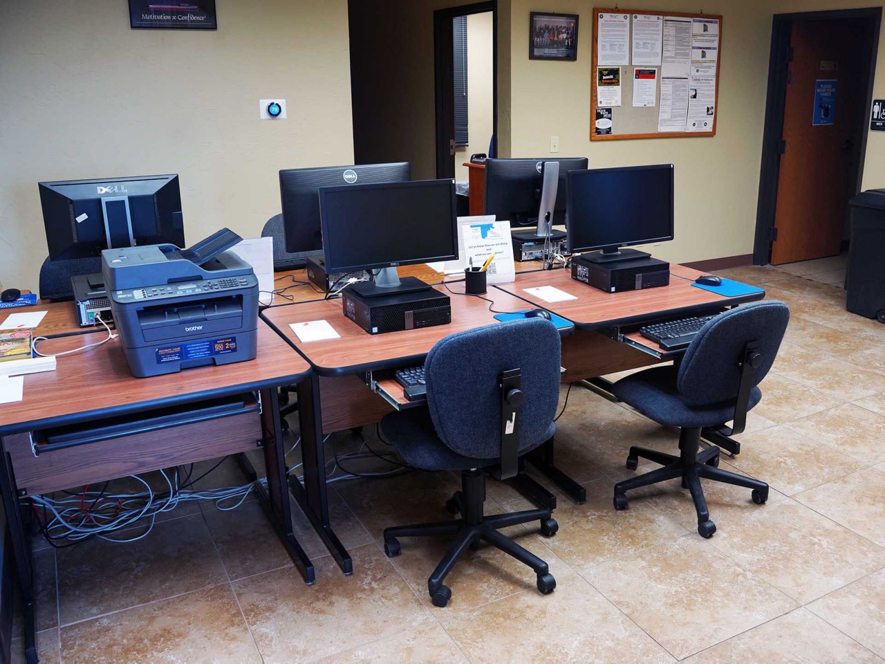 Resource area with computers and a printer/scanner/fax available to the public.                               
