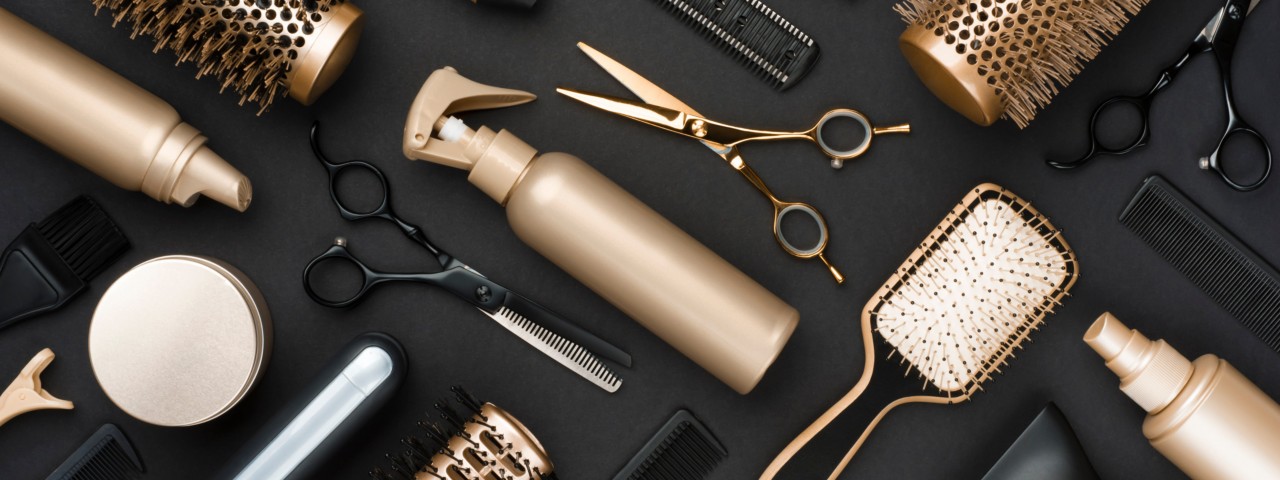Homepage Banner, a Full frame of professional hair dresser tools on black background