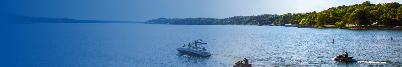 boats in lake with trees and people