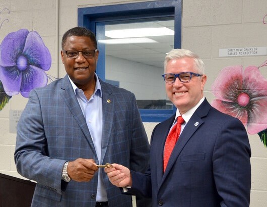 The GEO Group Senior Vice President James Black hands over the key to GPCC to Dir. Steven Harpe.