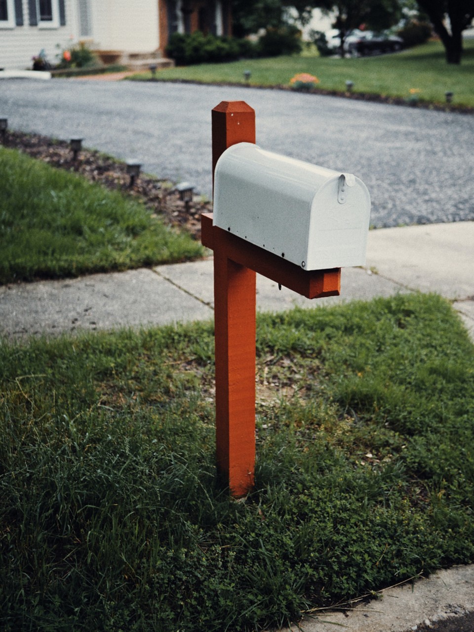 Picture of a mailbox outside a house on the curb