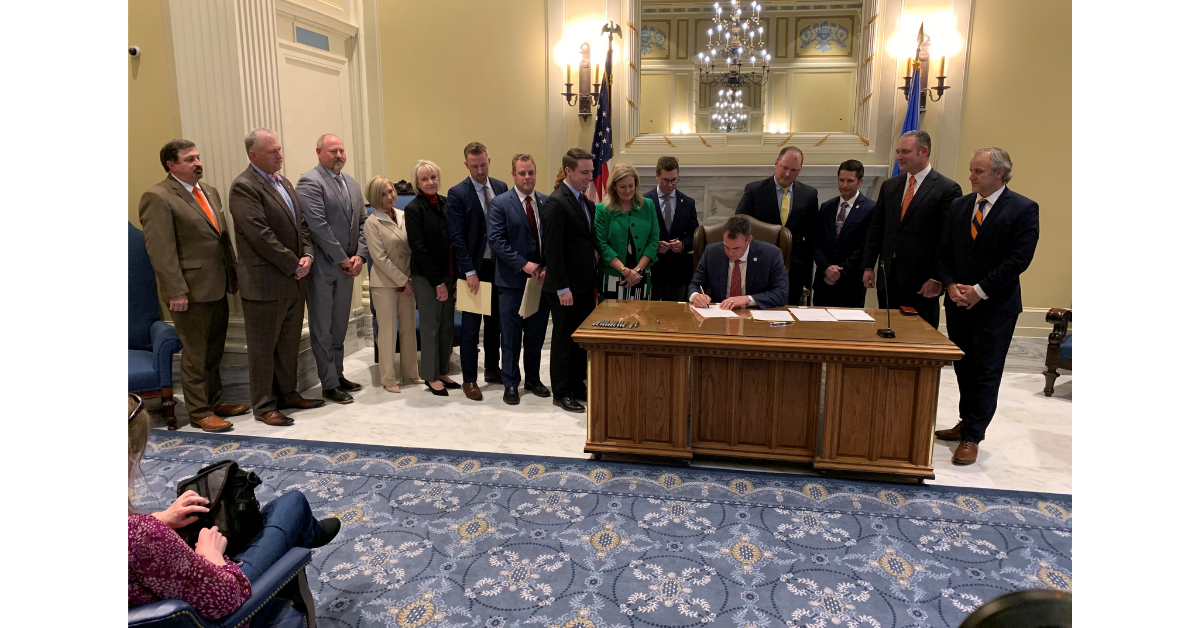 Governor Stitt Signing bill