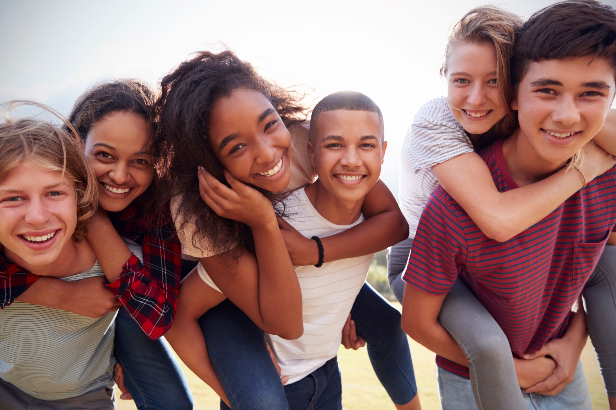 A group of teens enjoys time together. A group of teens enjoys time together.