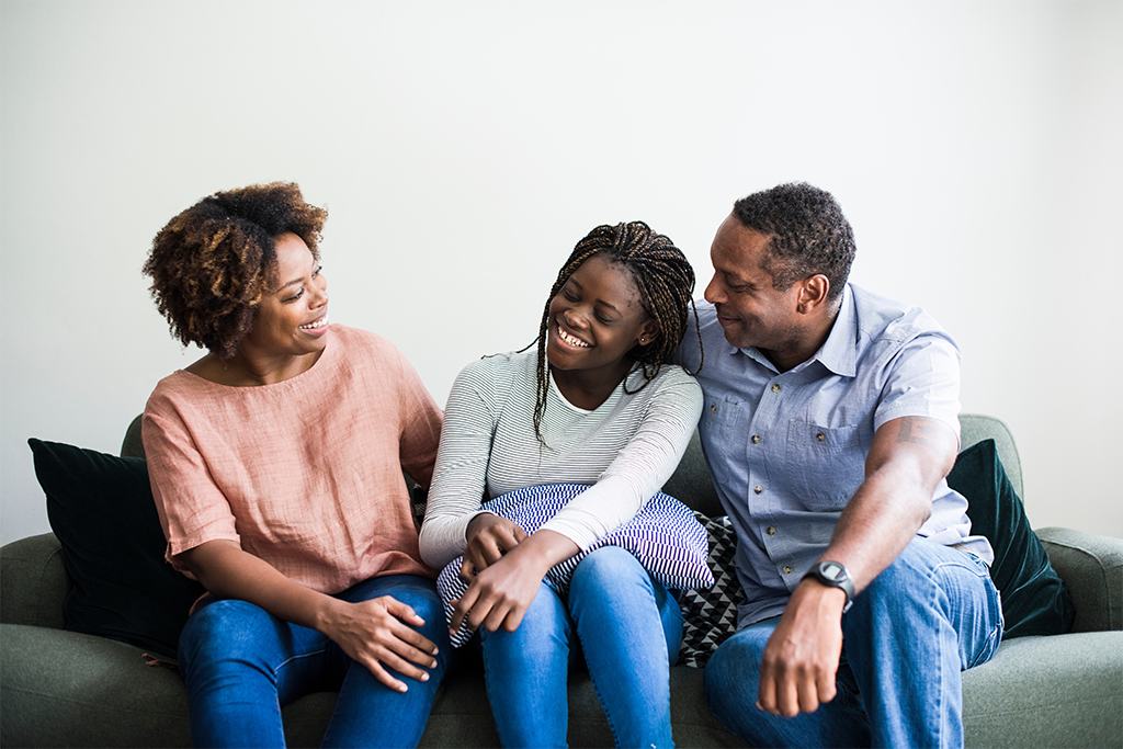 A family of three shares a happy moment. A family of three shares a happy moment.