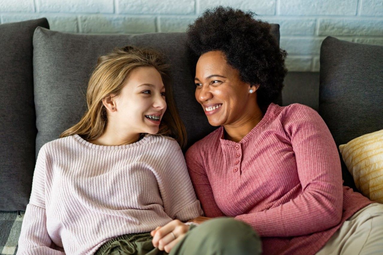 A loving foster single mother embraces teen daughter.