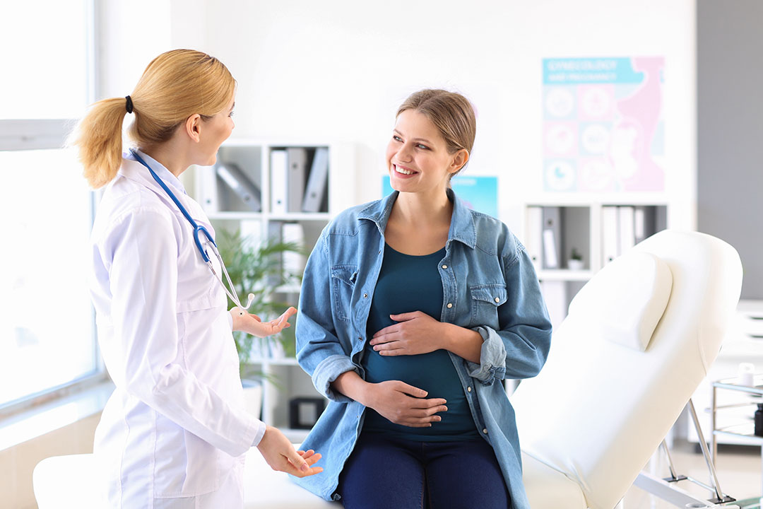 Young pregnant woman visiting her gynecologist in clinic Young pregnant woman visiting her gynecologist in clinic
