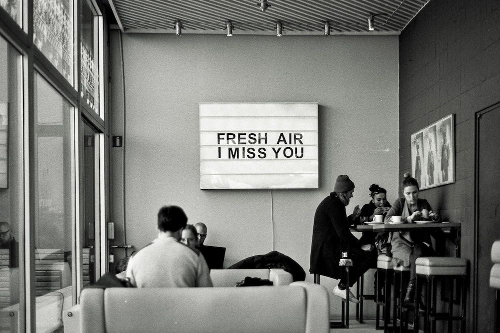 A sign in a restaurant reads "Fresh Air I Miss You." A sign in a restaurant reads "Fresh Air I Miss You."