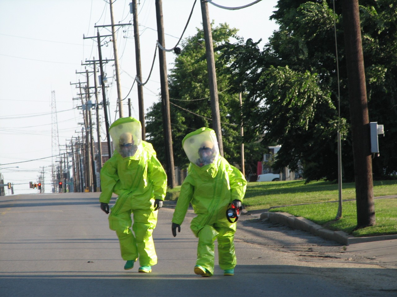 Two people in protective suits from the Muskogee RRS team