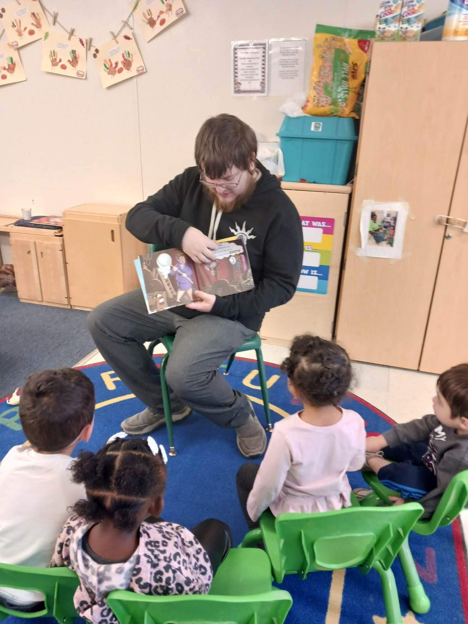 Kolten reading to children at My First Library event