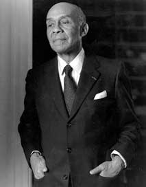Ralph Waldo Ellison Mr. Ellison wearing a coat and tie with his hands in his pockets.