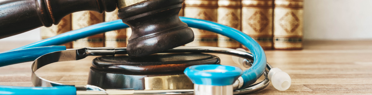 Medical law books, with gavel and stethoscope 