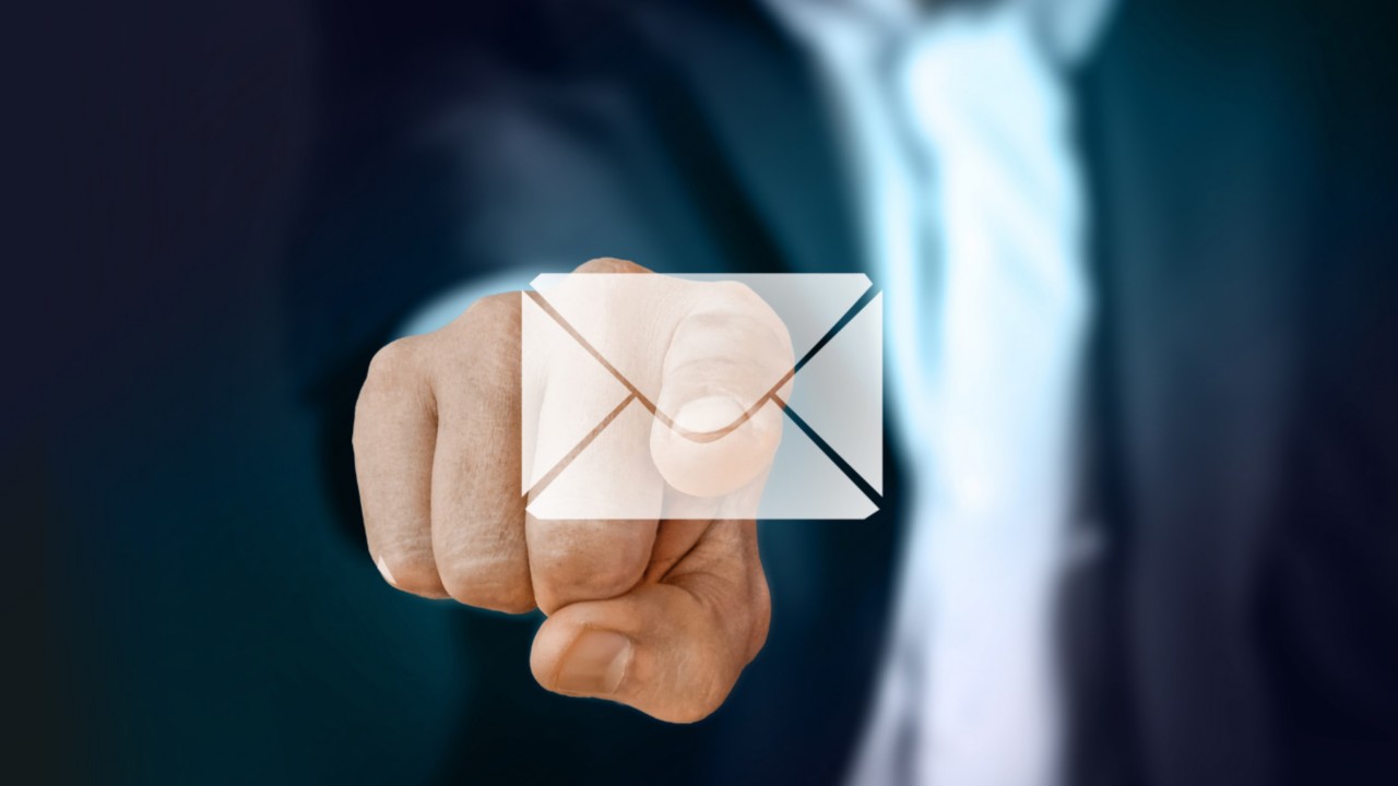 Man pointing a the screen, touching an email icon signifying an email notification